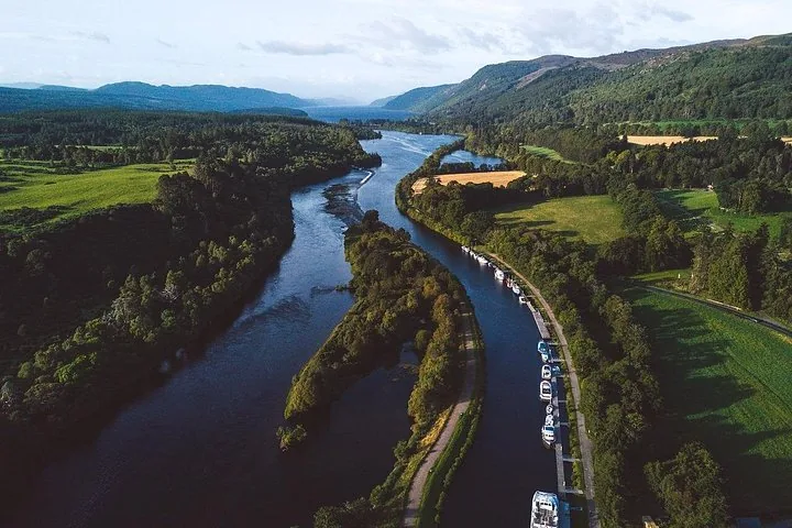 Aerial view of a river or canal winding through a lush, green landscape.